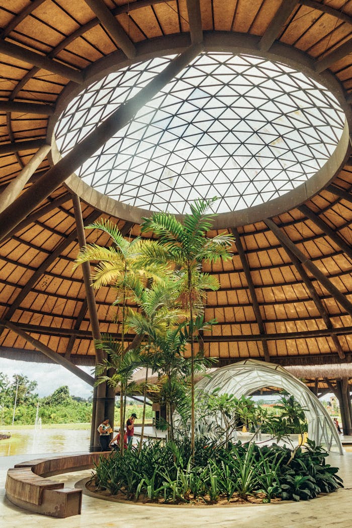 Spacious indoor garden with glass skylight in a modern architectural structure in Brazil.